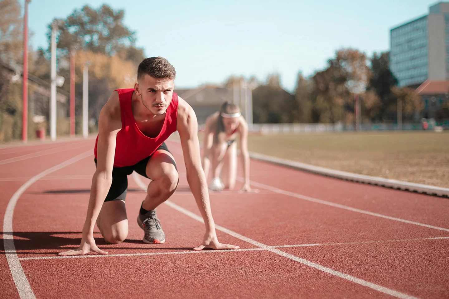 A runner gets ready to race at the start line.